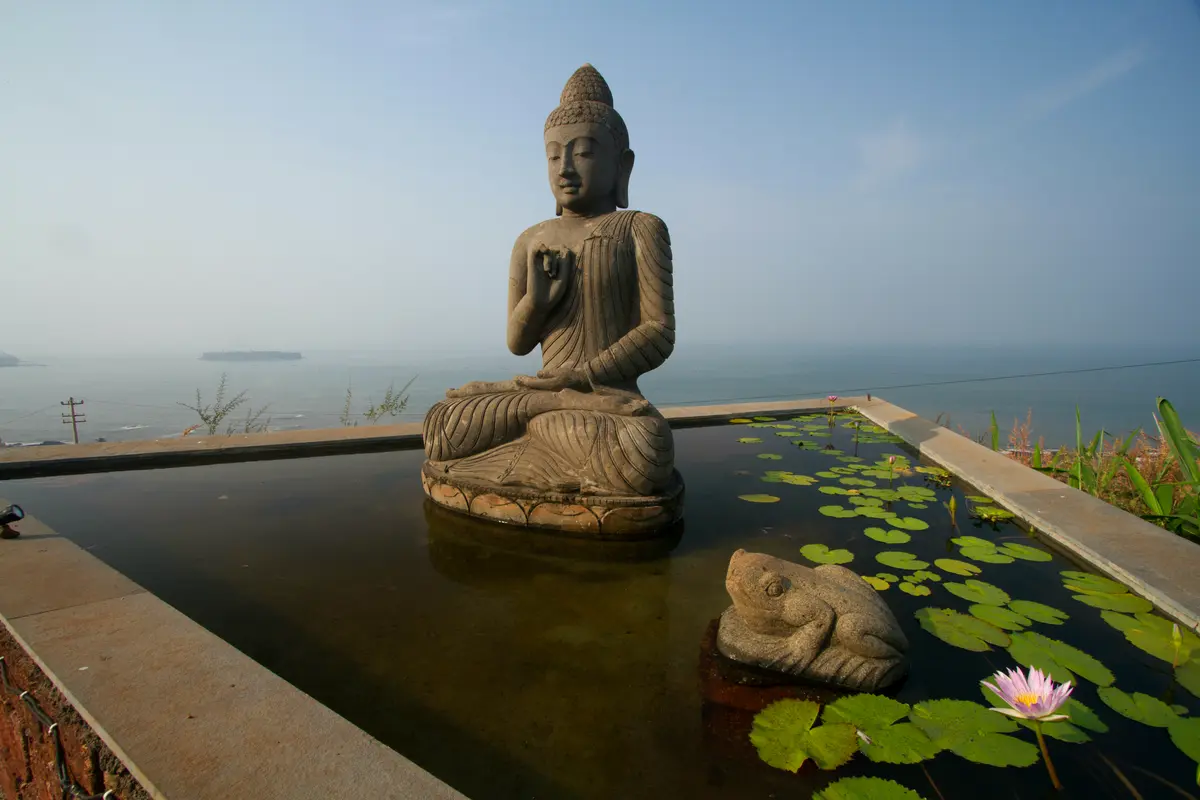 This intricately carved Buddha statue made of volcanic rock sits at the centre of the pond. This and several other rustic artefacts have been brought in from Bali. 