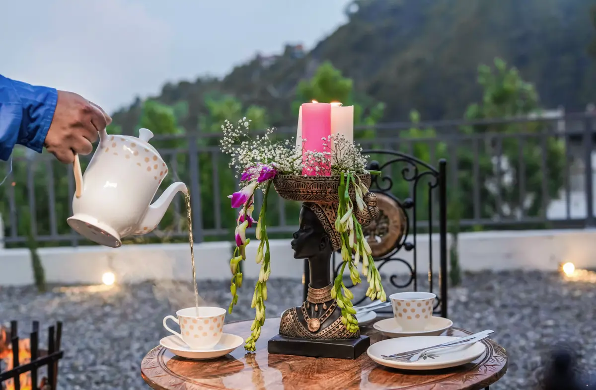 Enjoys evening tea with a view.