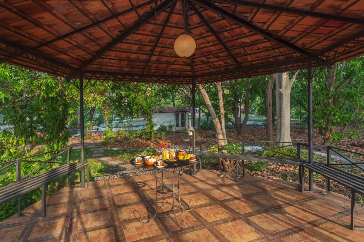 Enjoy the picturesque beauty in the gazebo as the sky turns scarlet due to the setting sun.