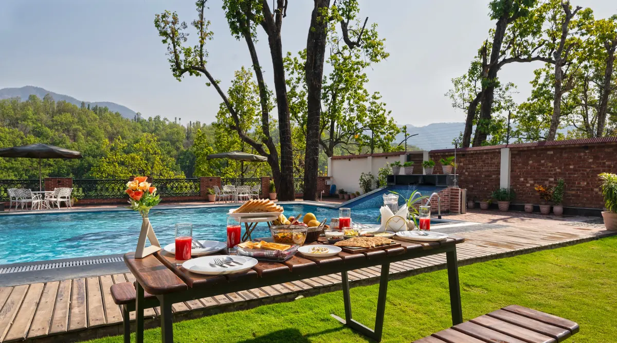 Poolside breakfast with a sun-drenched open garden