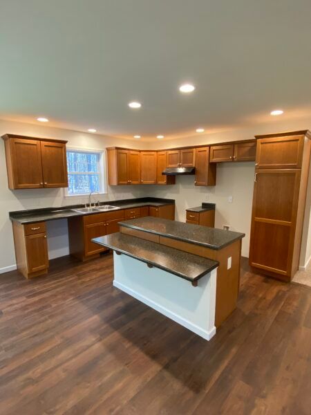 cherry kitchen with island of new modular ranch home project completed by Brookewood Builders, Manchester, ME 04351