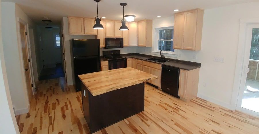 kitchen with island in new custom modular cape home completed by Brookewood Builders, Manchester, ME 04351