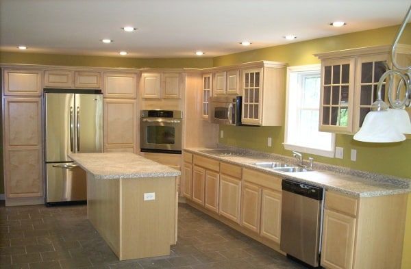 natural maple kitchen with island in new custom modular ranch home completed by Brookewood Builders, Manchester, ME 04351