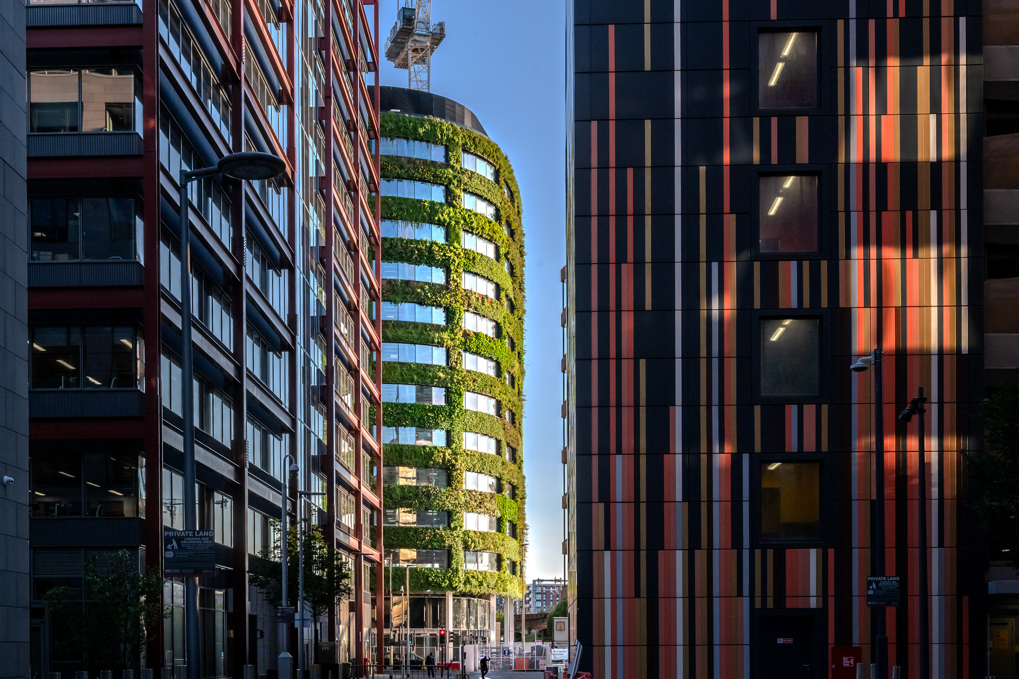A photography of Eden New Bailey and its green living wall with other buildings in the foreground