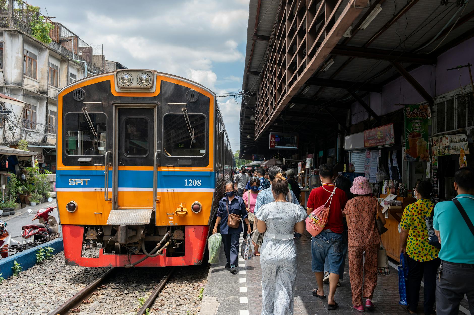 Tourists exploring vibrant local markets and historic sites during luxury train stopover
