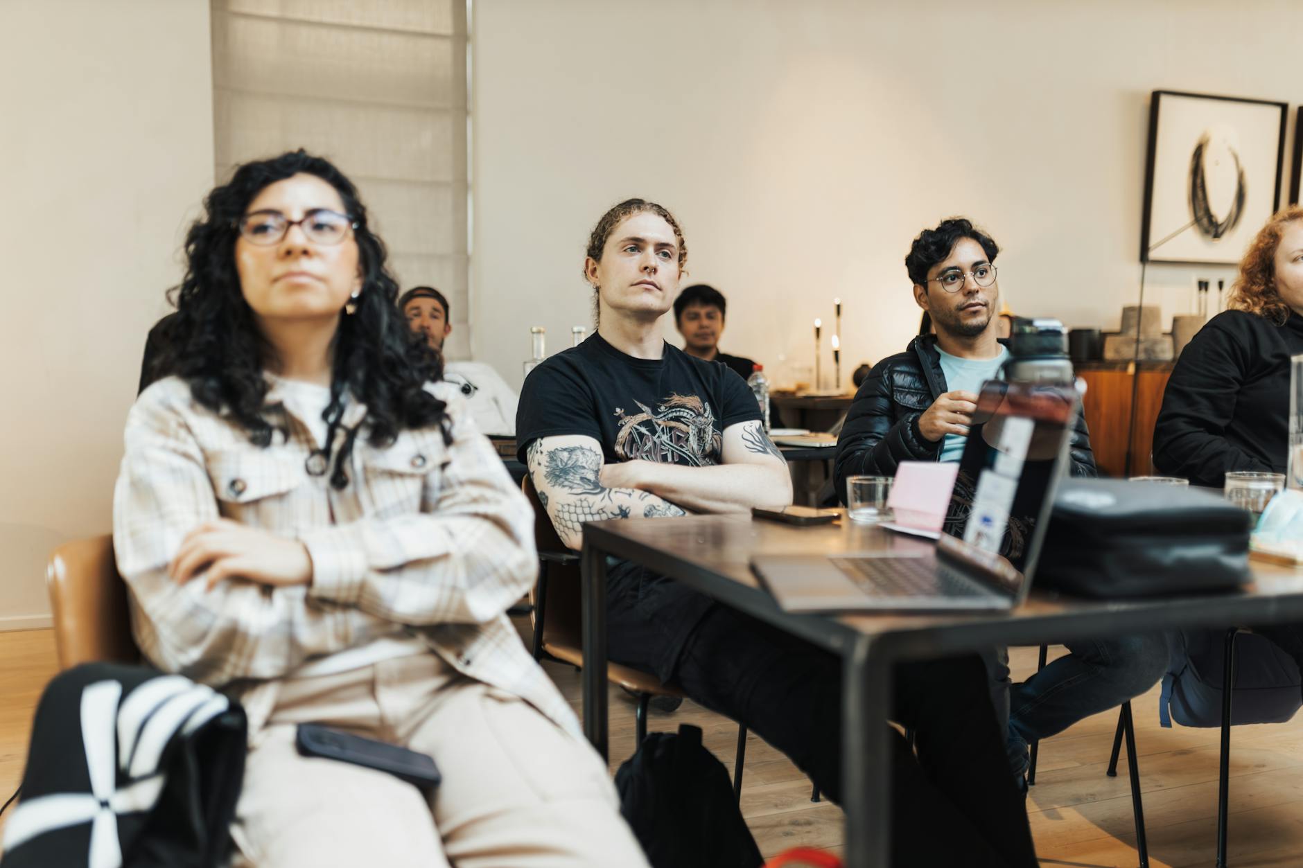 Luxury train attendant serving champagne to passenger reclining in spacious private cabin