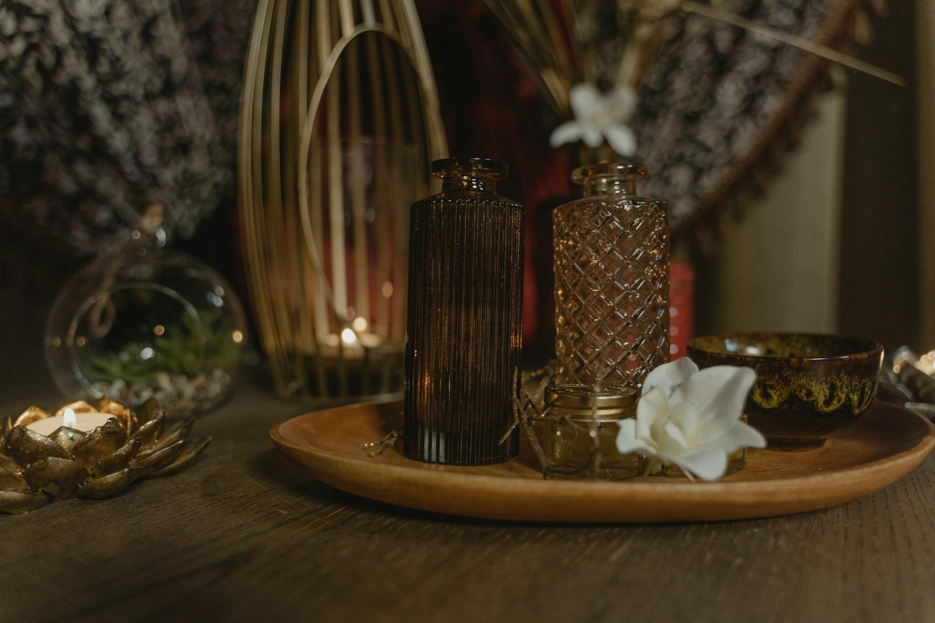Person reviewing wellness retreat brochures and laptop with notes on preferences at a cozy home desk