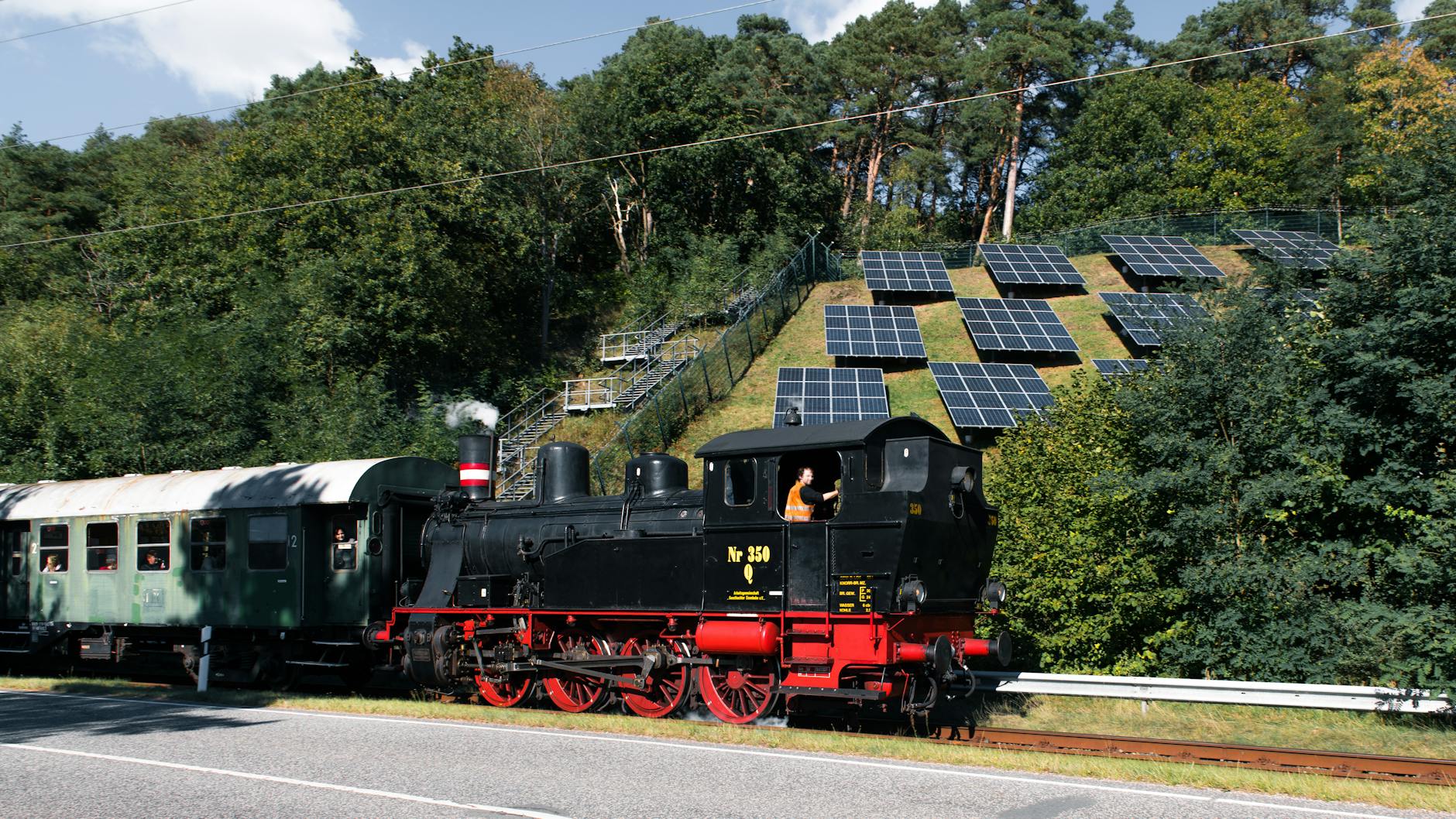 Futuristic luxury train powered by solar panels rolling through green countryside