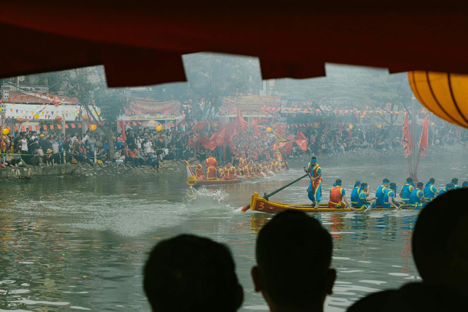 Participants carrying a decorated dragon boat during a festival in Quảng Ngãi, Vietnam.