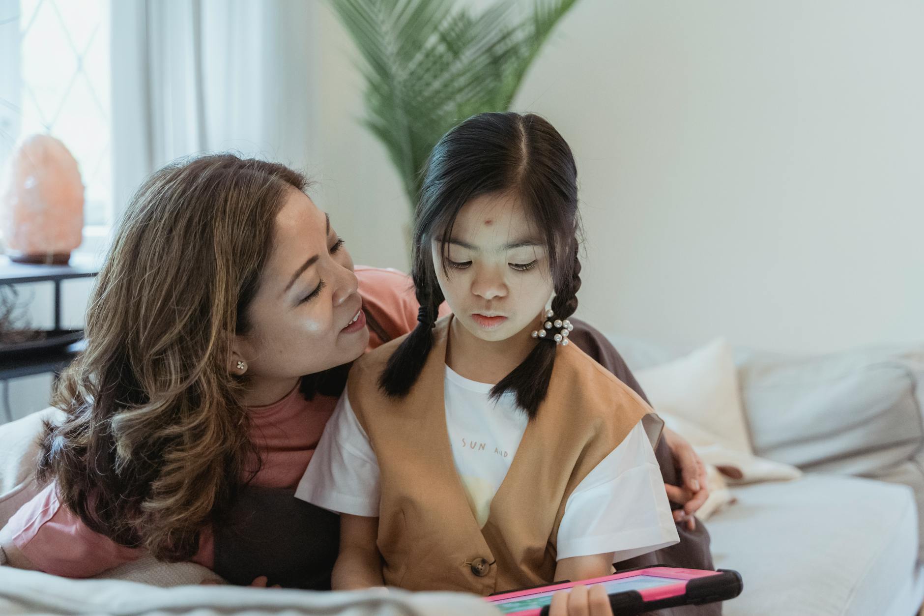 Person typing on laptop with FAQ webpage on healing-themed wellness travel packages