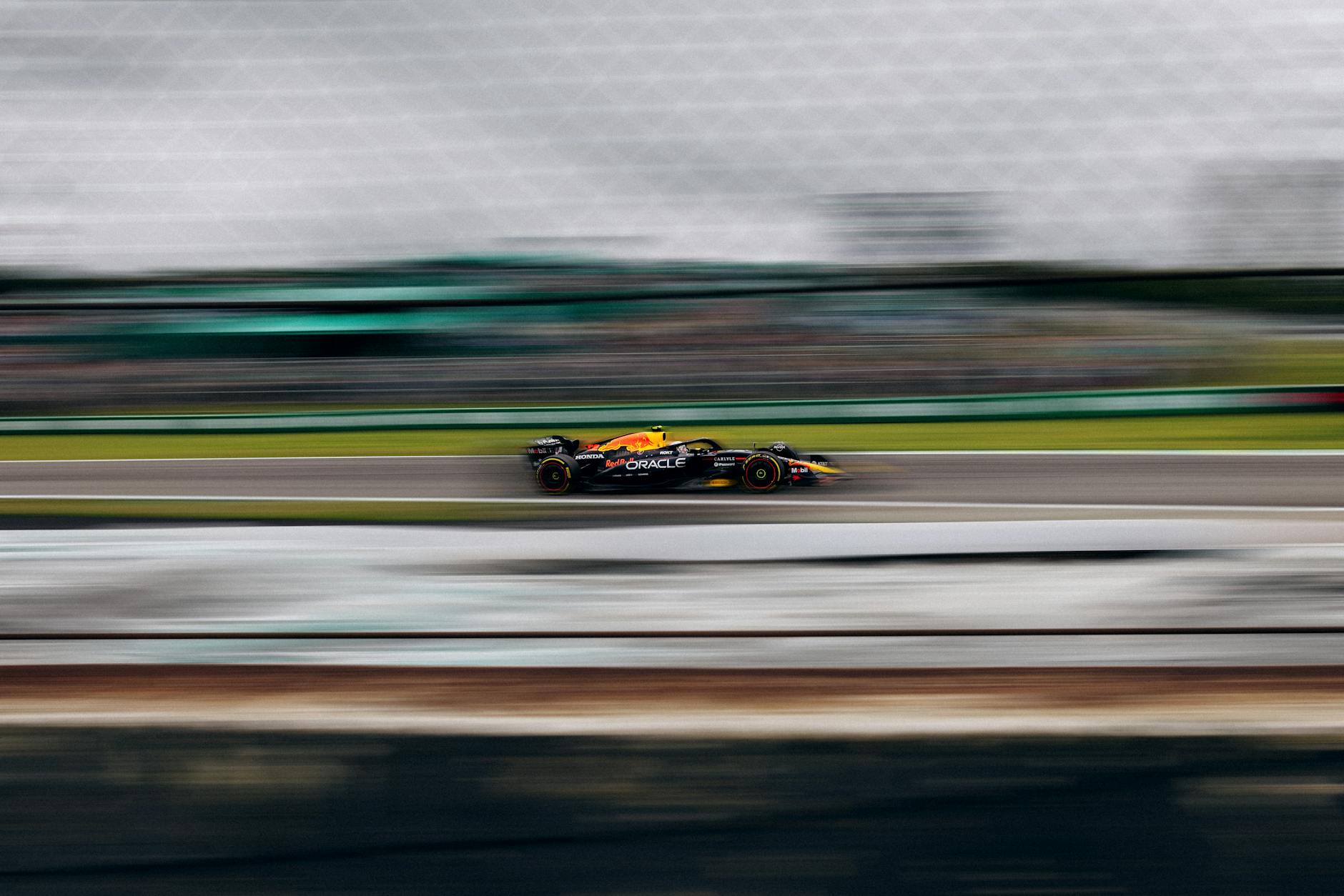 High-speed Formula 1 cars racing on Monaco’s iconic street circuit with crowded grandstands