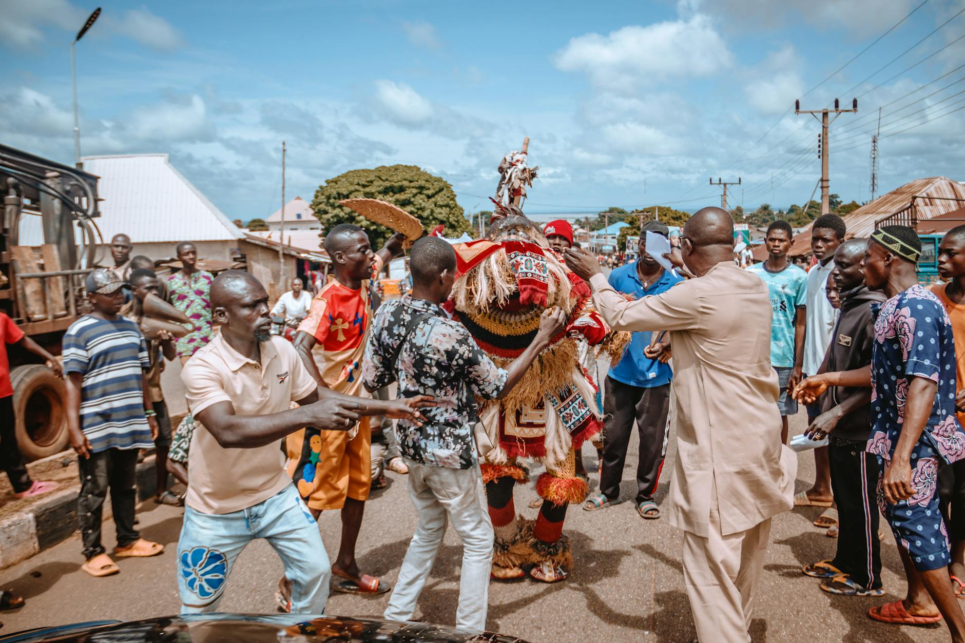 Exciting ox-racing festival in rural landscape by a temple, showcasing traditional culture.