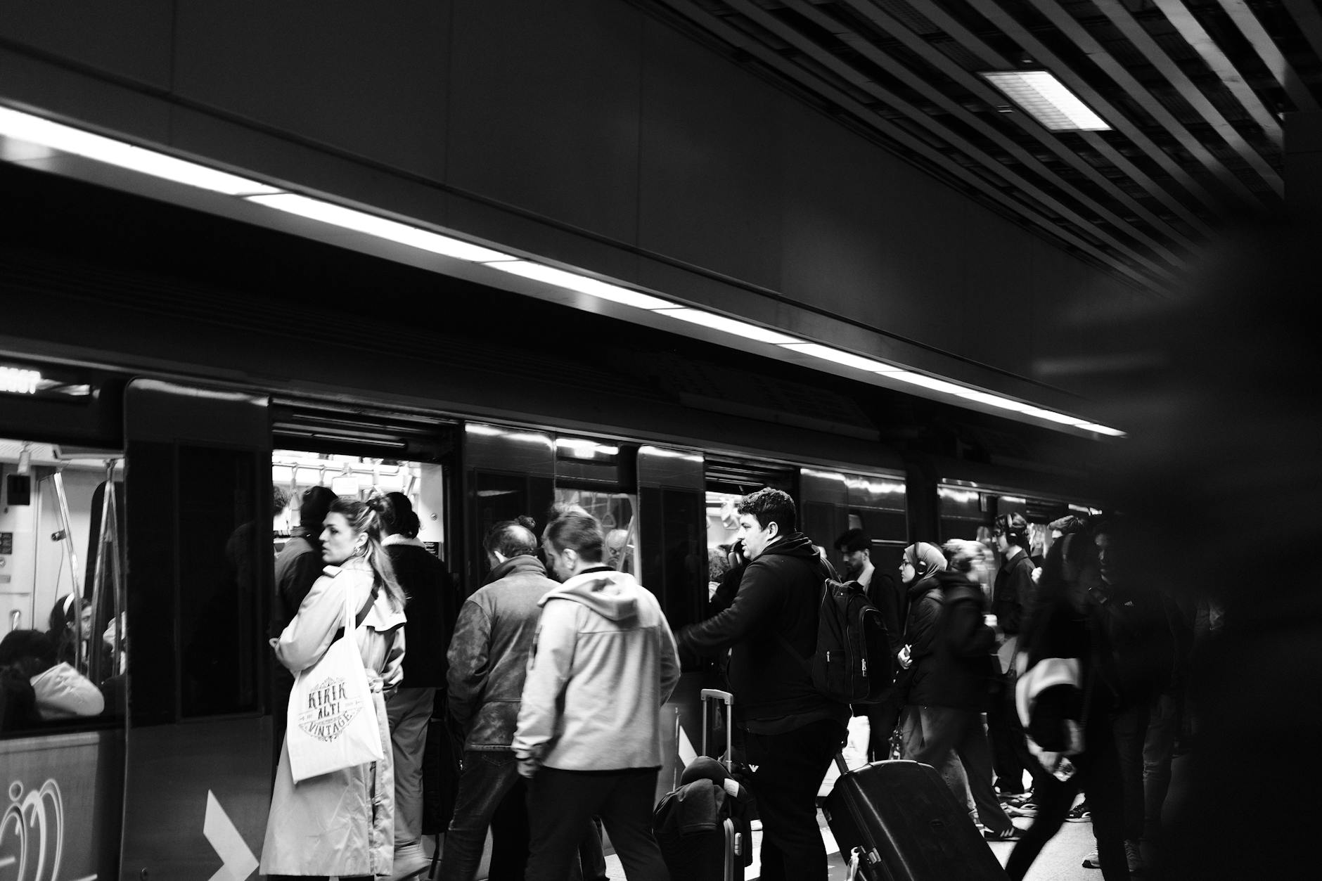 Crowded luxury train platform with frustrated travelers and tight itineraries displayed