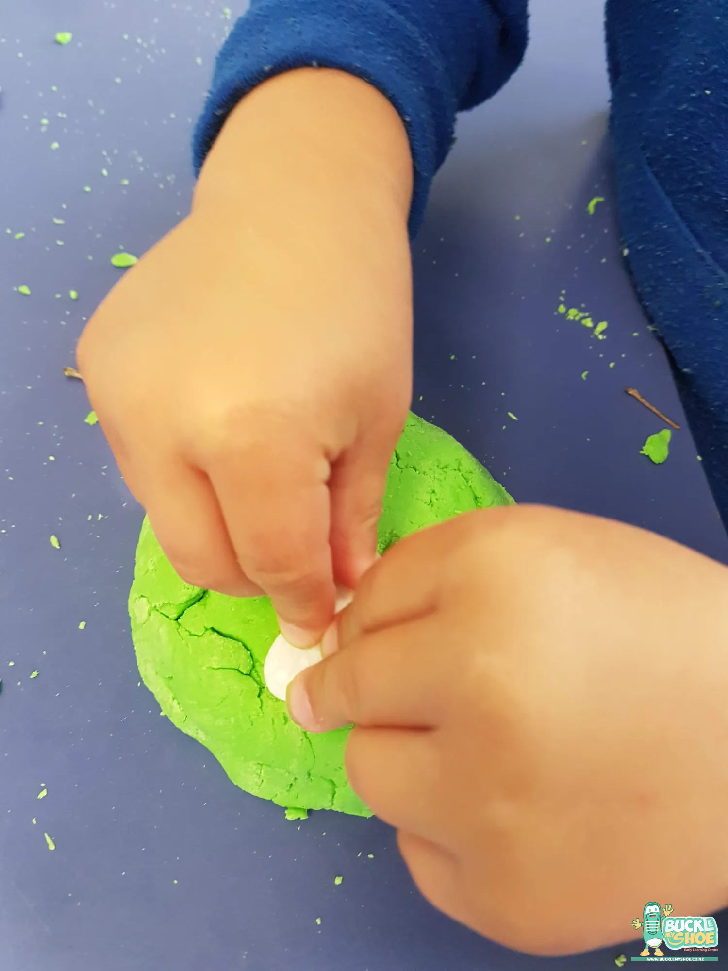 Buckle My Shoe Tauranga & Papamoa | Childcare, Preschool, Daycare | Small pebbles carefully placed to form a path through the dough.