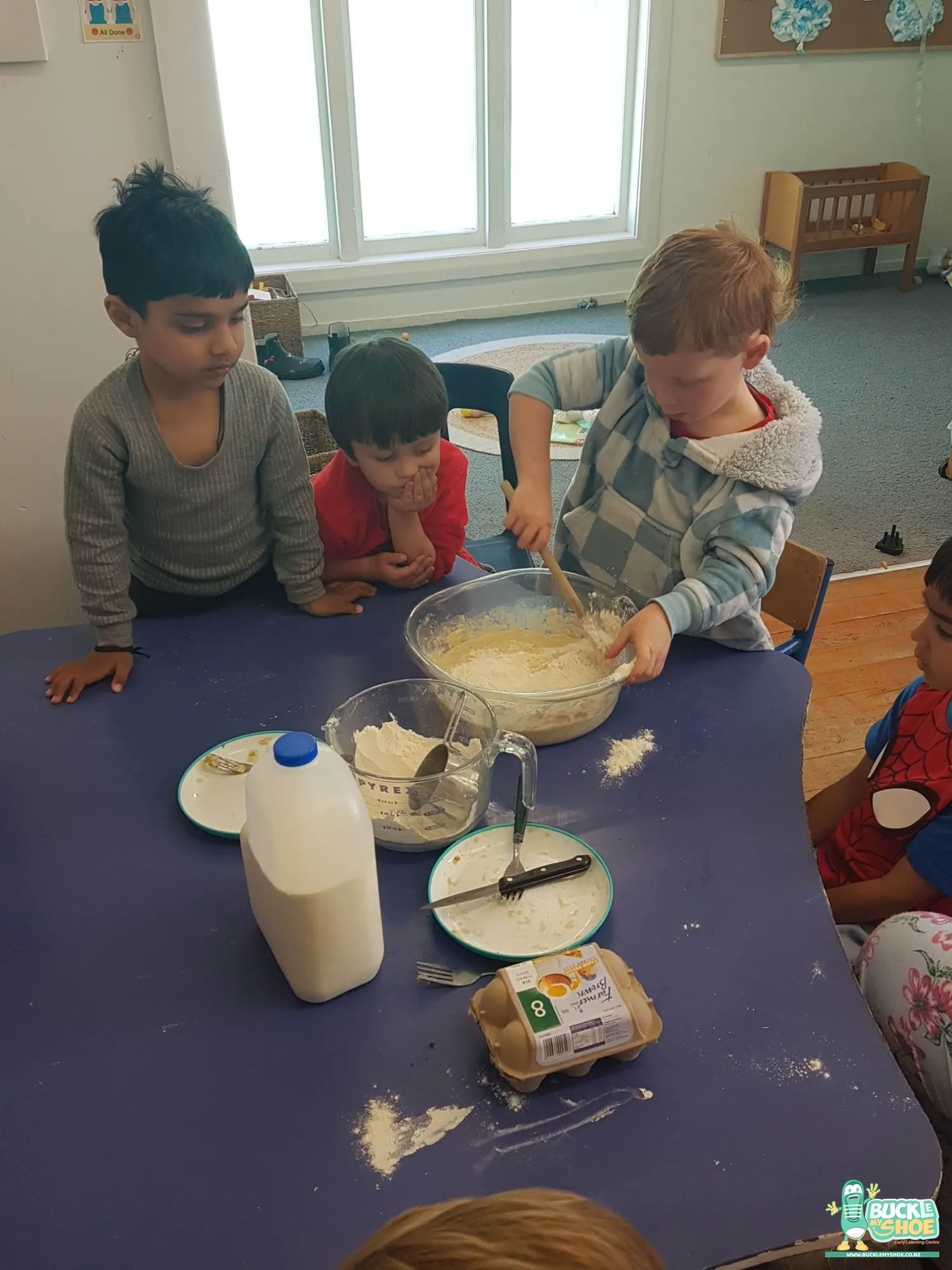 Buckle My Shoe Tauranga & Papamoa | Childcare, Preschool, Daycare | A child holding up a heart shaped cookie with a big smile.