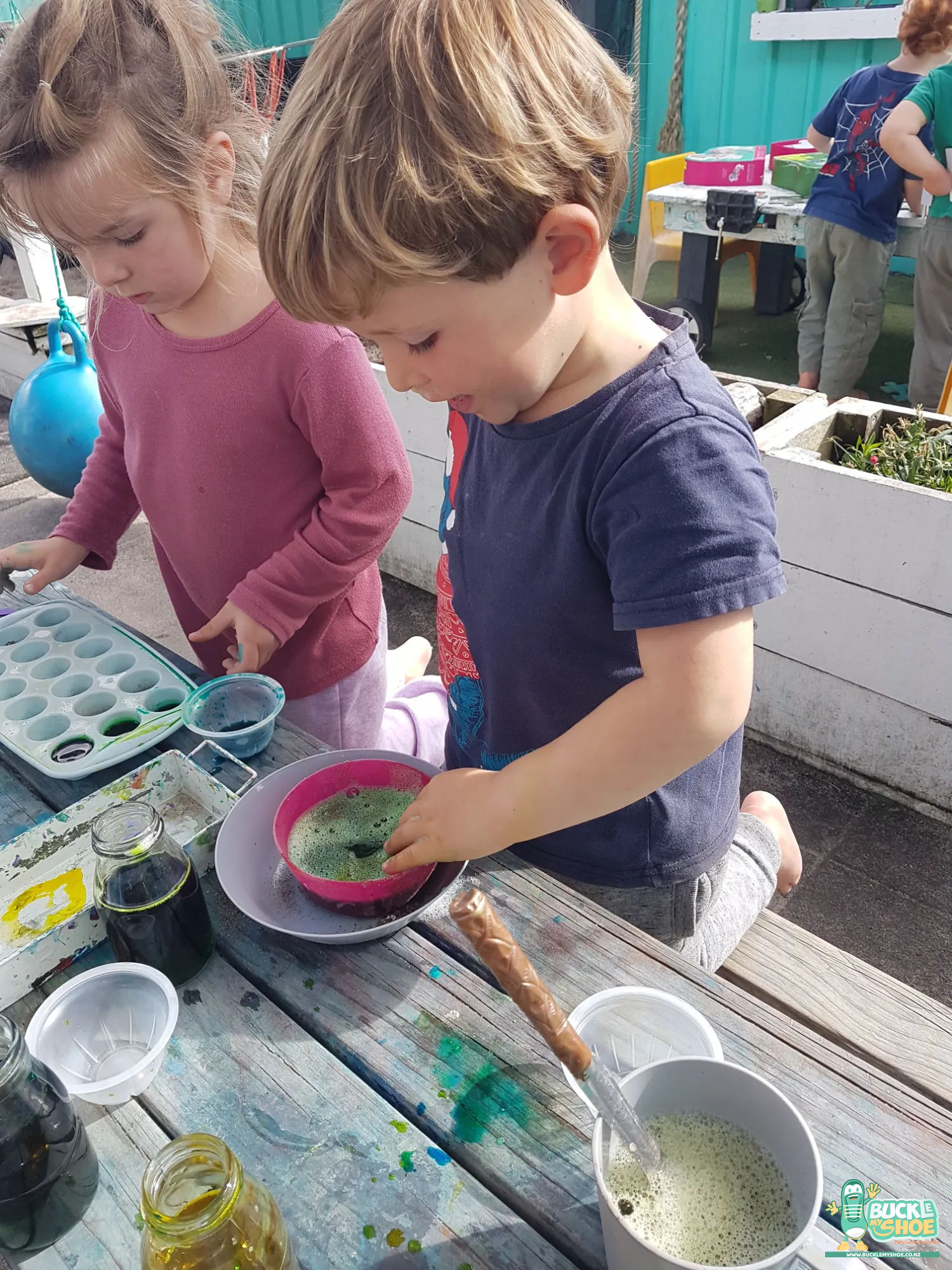 Buckle My Shoe Tauranga & Papamoa | Childcare, Preschool, Daycare | A child gathering natural leaves and sand from the garden for potions.