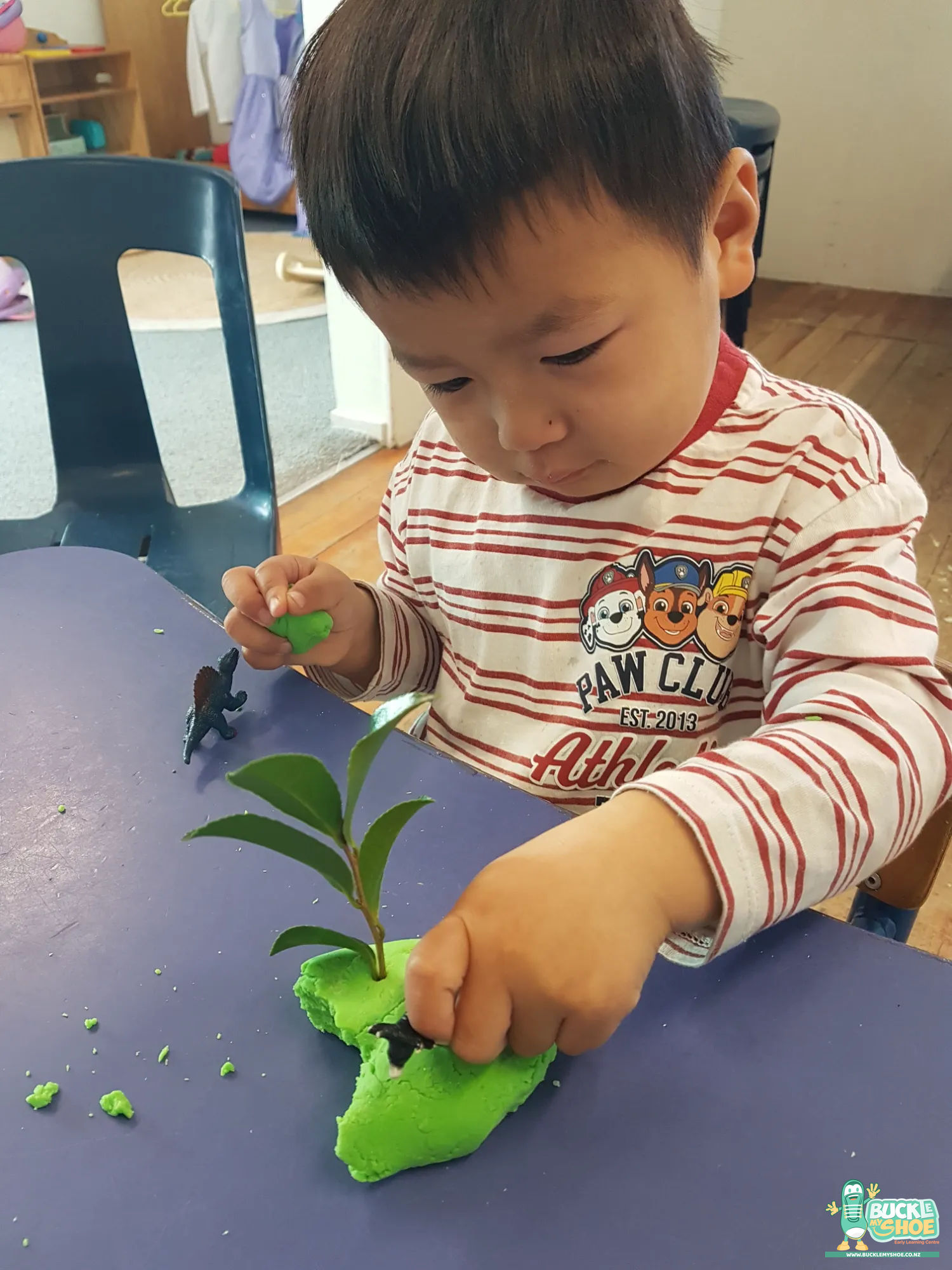 Buckle My Shoe Tauranga & Papamoa | Childcare, Preschool, Daycare | A child holding a smooth rock representing a mountain for animals.