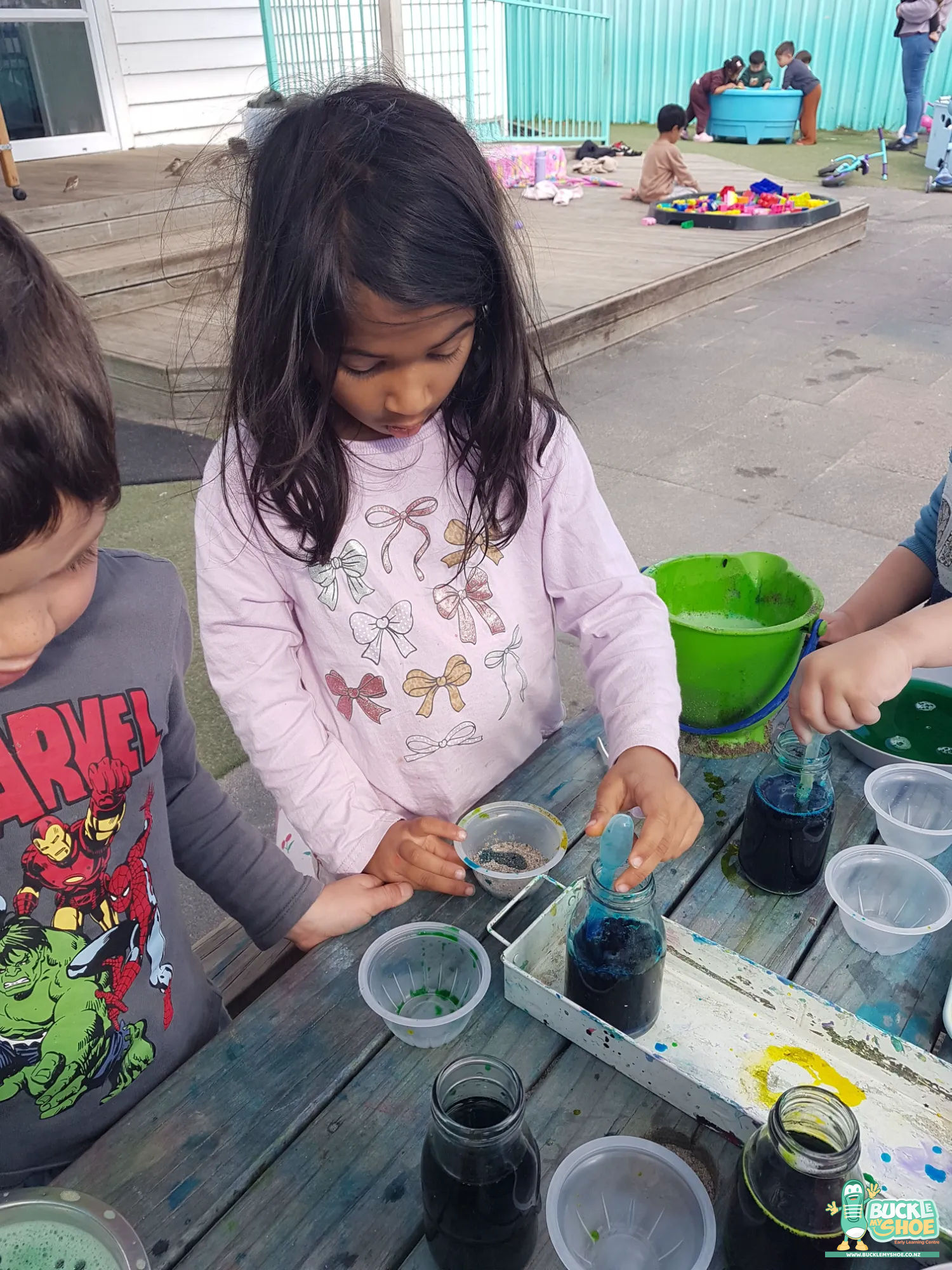 Buckle My Shoe Tauranga & Papamoa | Childcare, Preschool, Daycare | Small hands reaching eagerly for plastic droppers and spoons to start experimenting.