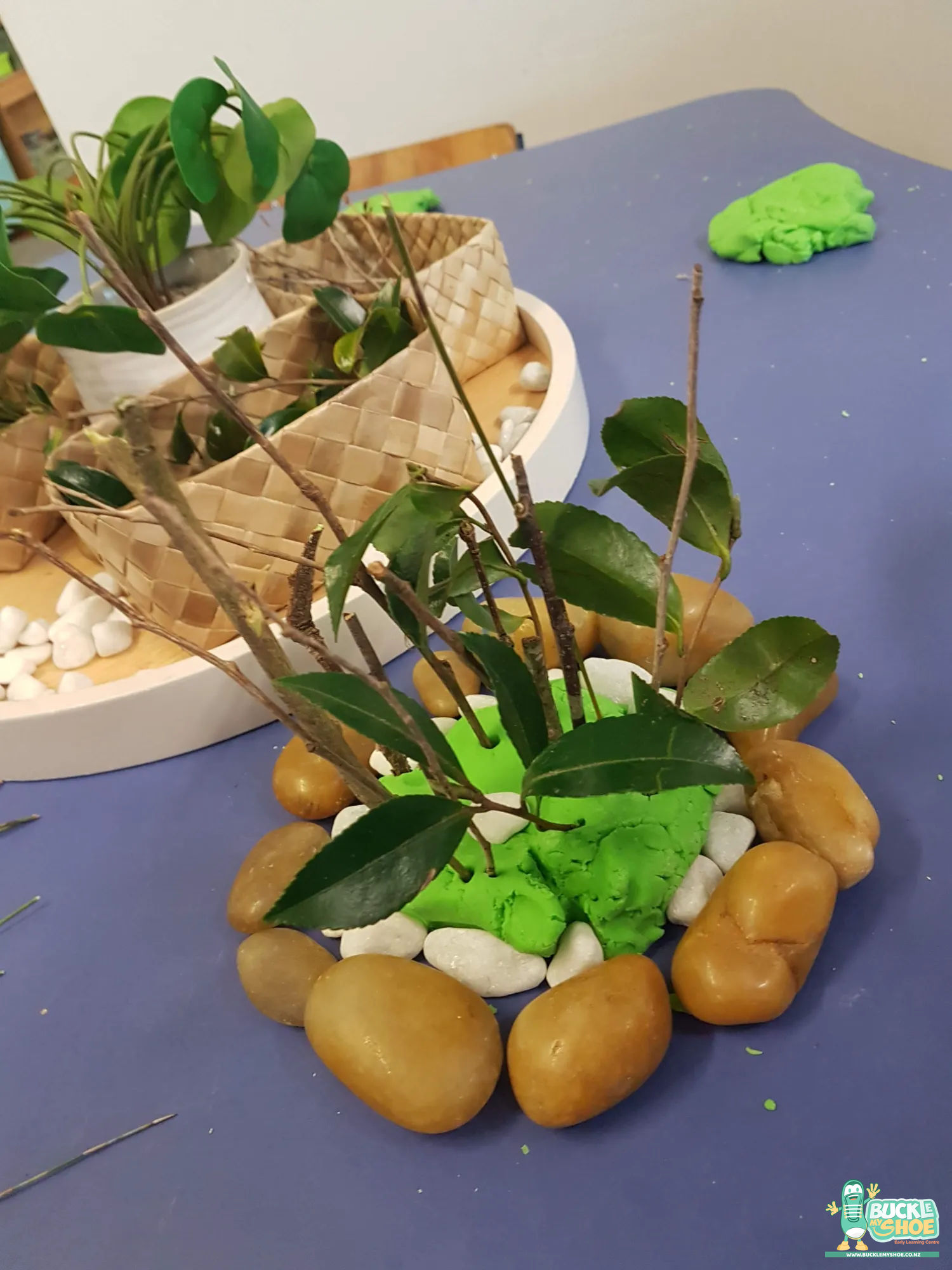 Buckle My Shoe Tauranga & Papamoa | Childcare, Preschool, Daycare | Two children collaborating to build a forest landscape on the table.