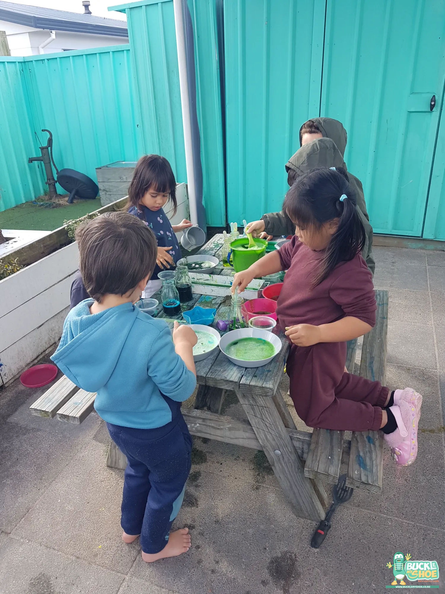 Buckle My Shoe Tauranga & Papamoa | Childcare, Preschool, Daycare | Playful hands covered in dirt and dye during the outdoor potion activity.