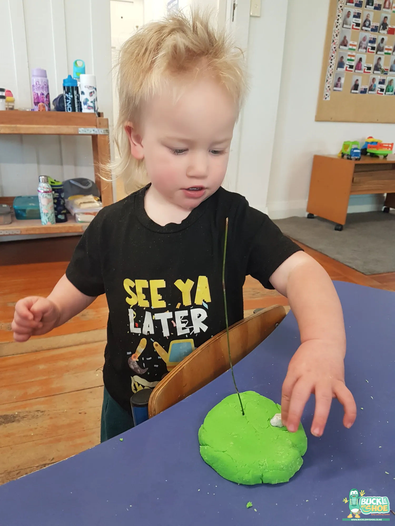 Buckle My Shoe Tauranga & Papamoa | Childcare, Preschool, Daycare | A kaiako kneeling beside a child to celebrate their creative ideas.
