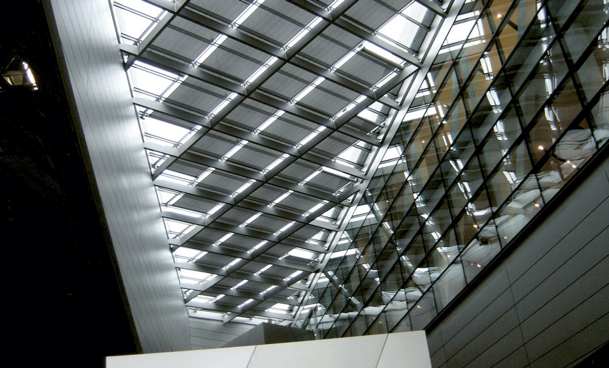 Die Fassade des Doppelkegels der BMW Welt in München ist grossflächig mit Glaspaneelen bedeckt. Gegenzuganlagen beschatten das angrenzende Hallendach und die nach innen geknickten Vertikalfassaden. (Fotos: Stephan Falk)