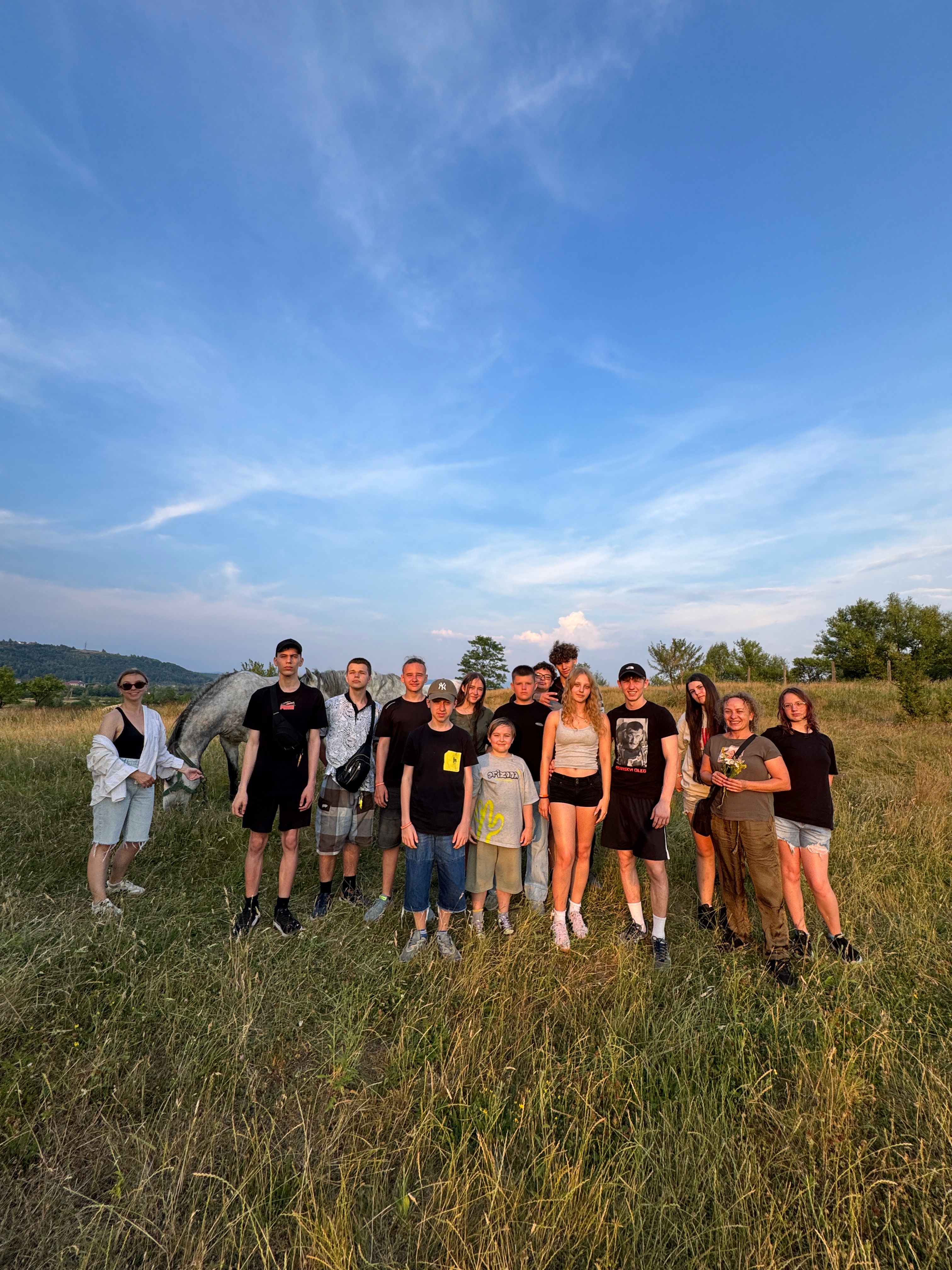 Camp participants together in a field under an open sky