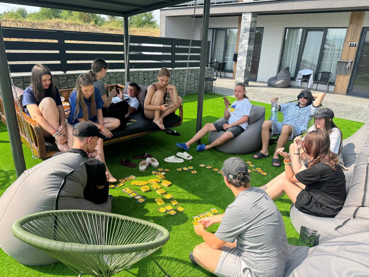 Camp participants and adults sitting together in an outdoor circle