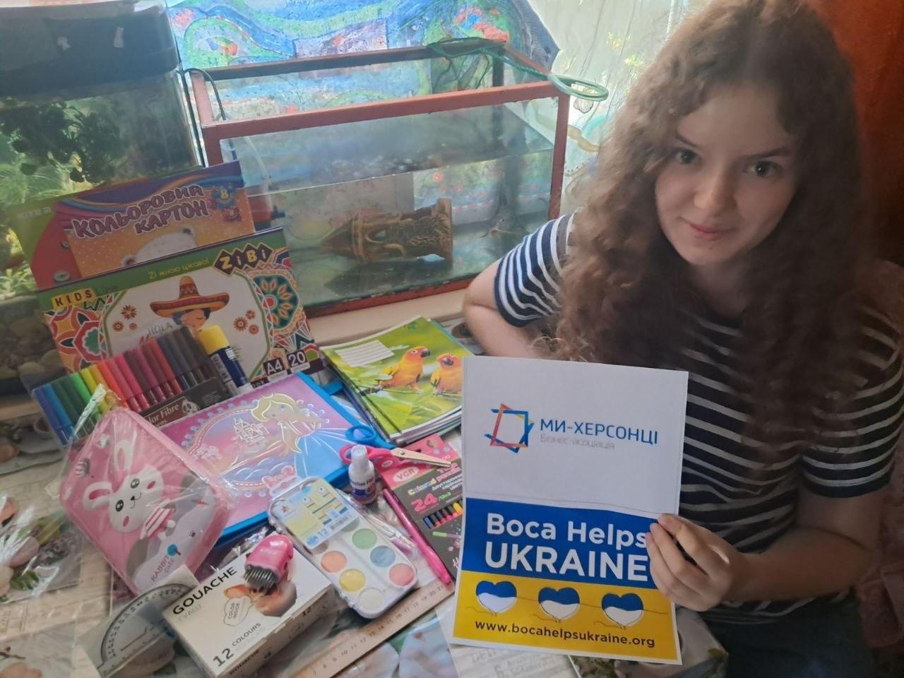 School and art supplies with a Boca Helps Ukraine sign
