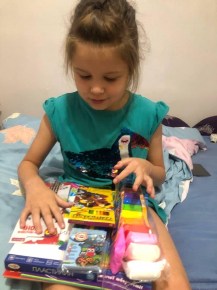 A child looking through a new set of art supplies