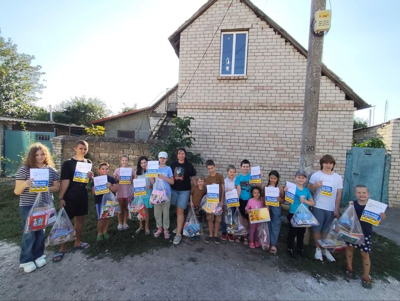 Families gathered outside with their school supplies