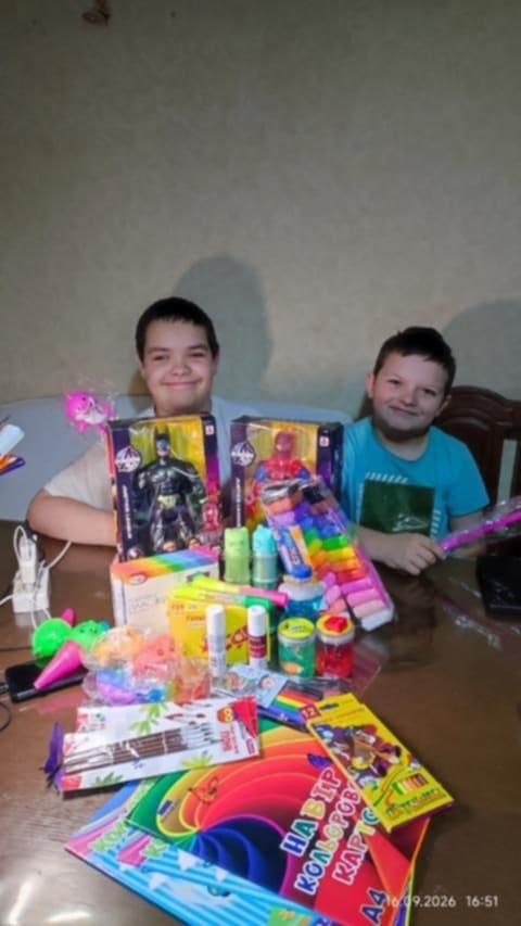 Two children with colorful school and art supplies