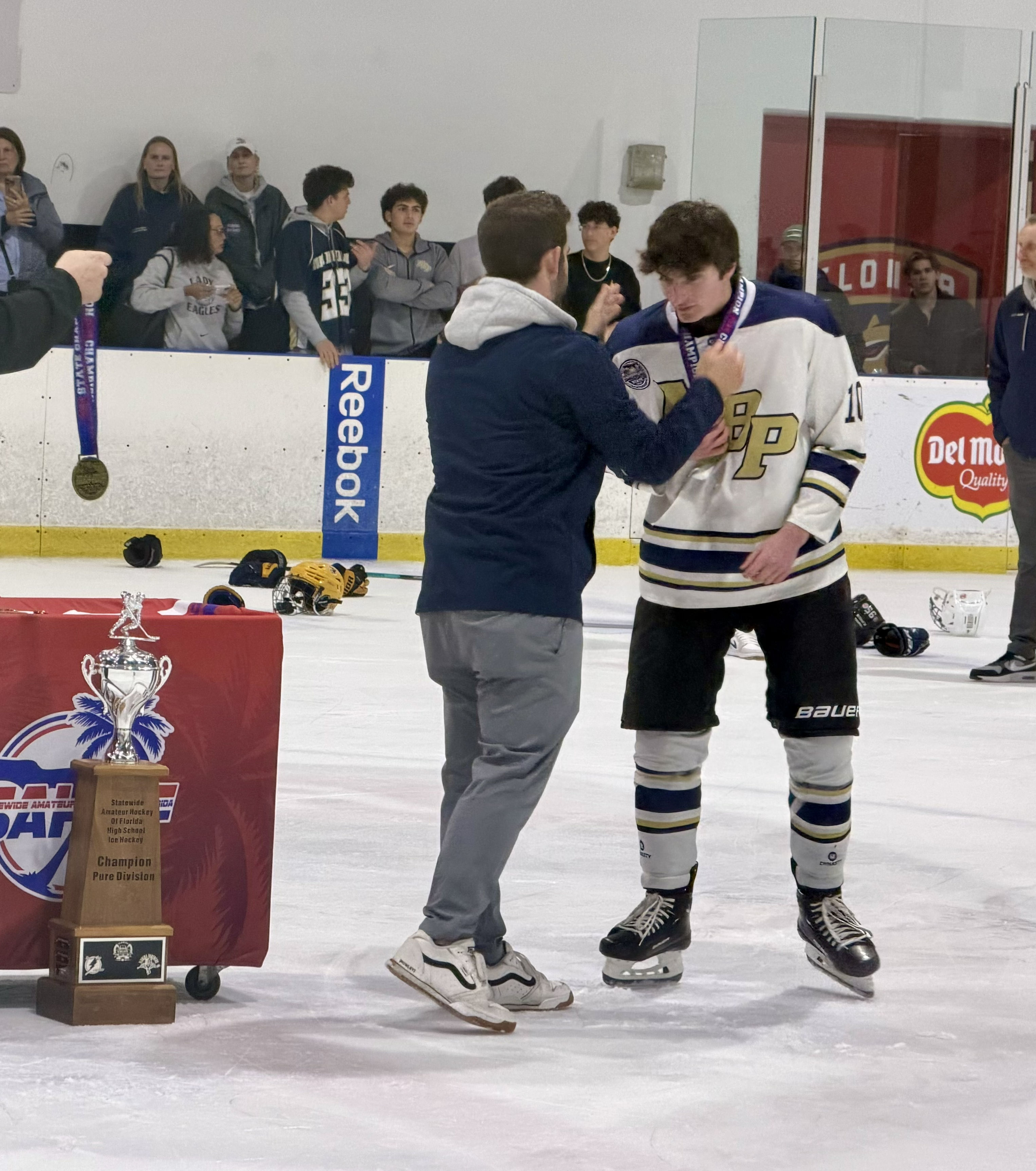 Cooper Reiss celebrating a varsity hockey state championship