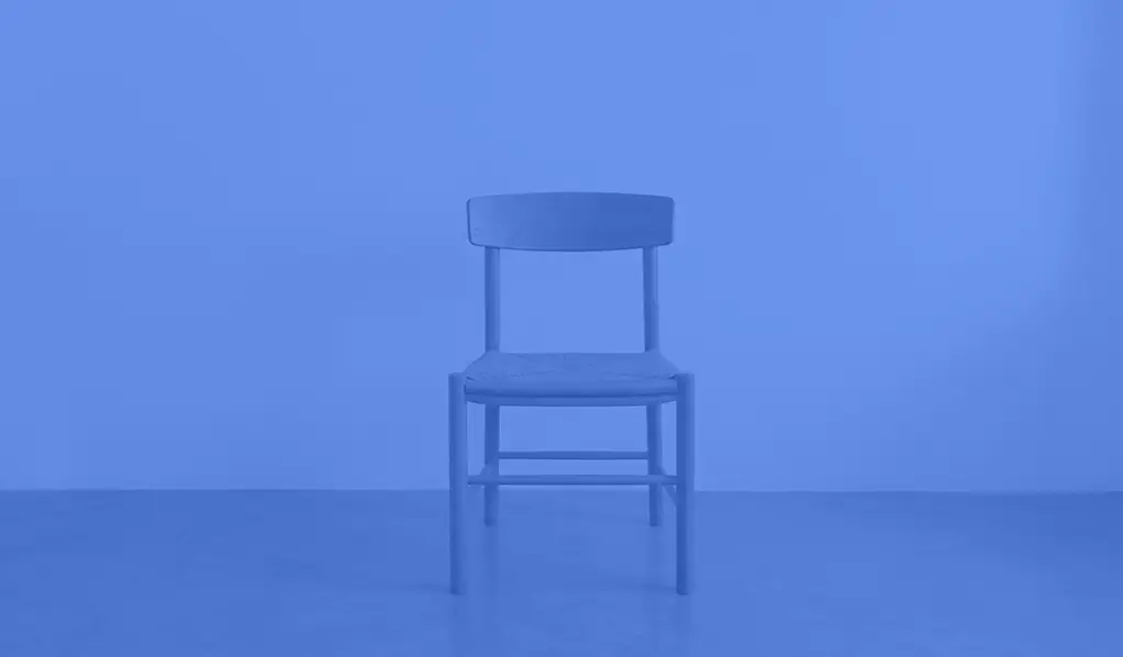 an image of an empty chair from Rokitsite with a medium blue coloured overlay