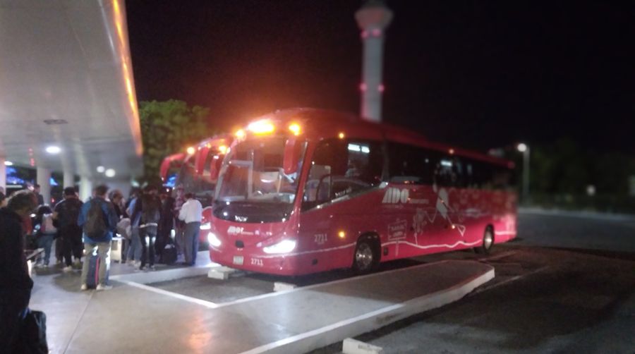An ADO bus loading at Cancun Airport, bound for the downtown Playa del Carmen station.