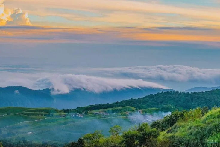 Clouds rolling over green hills at sunset in the Meghalaya highlands