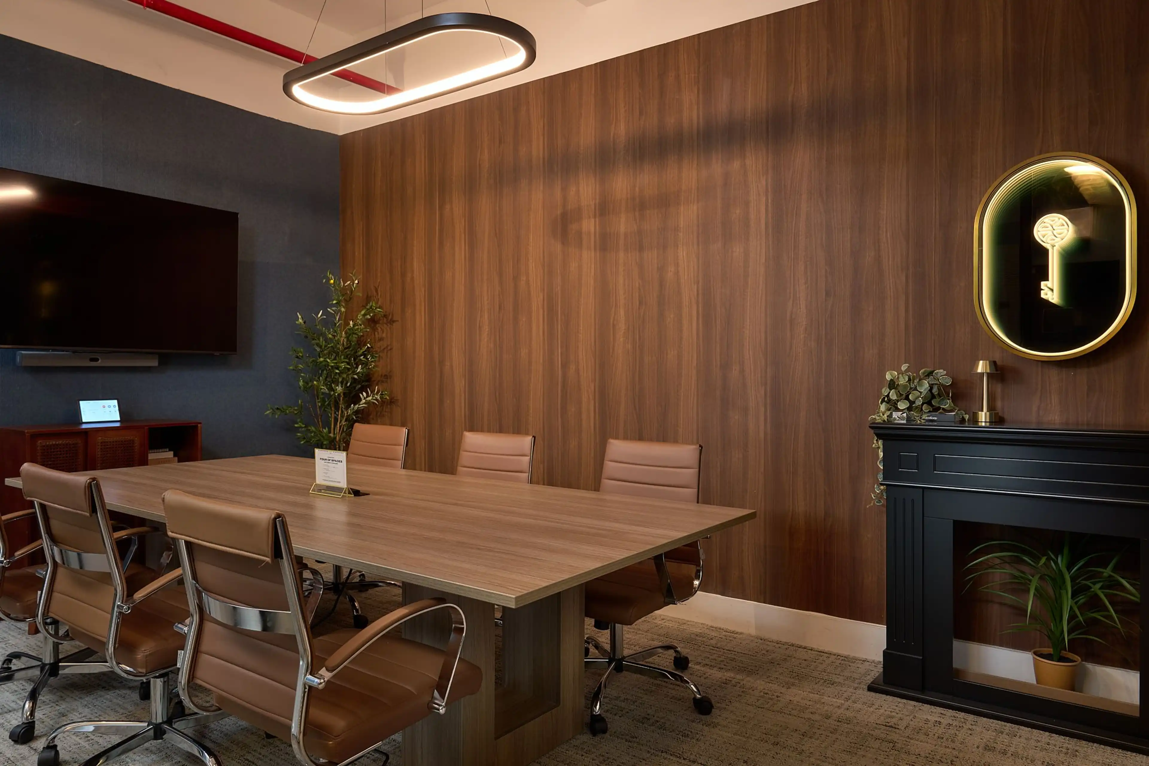 Flatiron District office corridor featuring blue accent walls, wood floors, and designer seating.