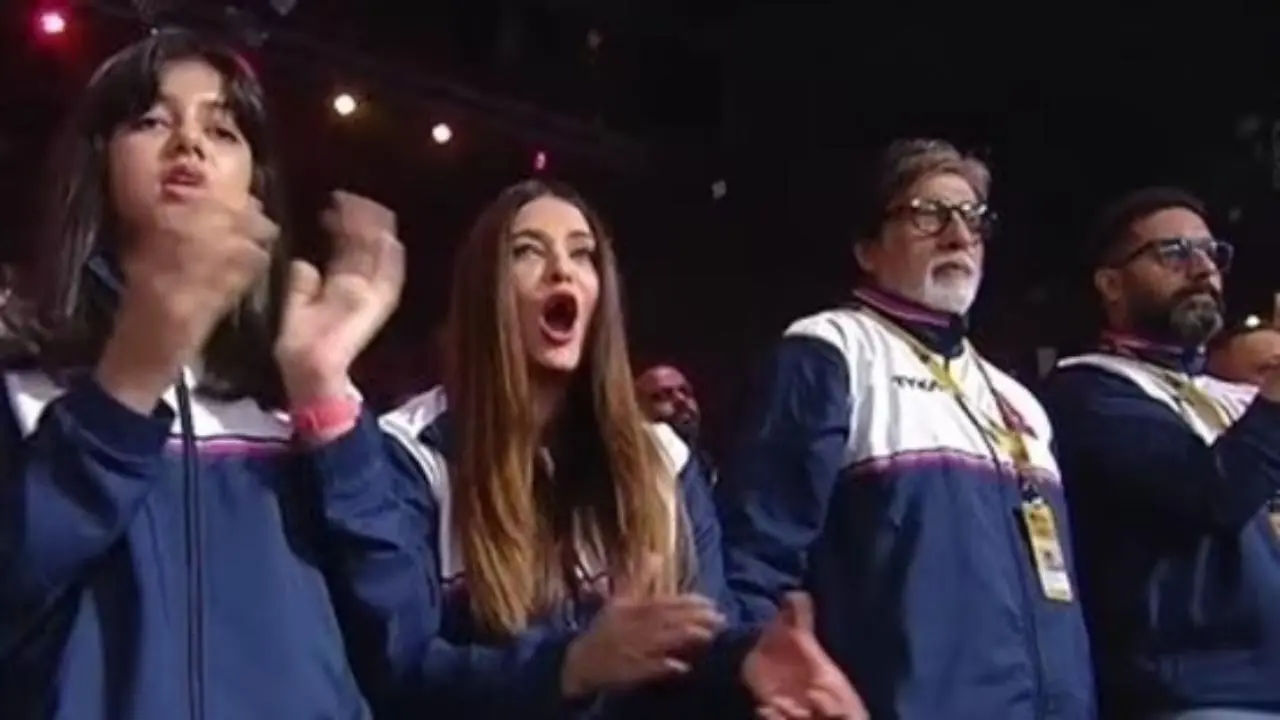 Fans yell, “tension utar gayi,” as Aishwarya Rai, Abhishek, and Amitabh Bachchan support the Jaipur Pink Panthers together.