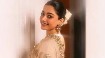 Rashmika as a Gond tribal woman, complete with traditional saree and jewelry, and a striking, blood‑smeared cinematic aesthetic  .