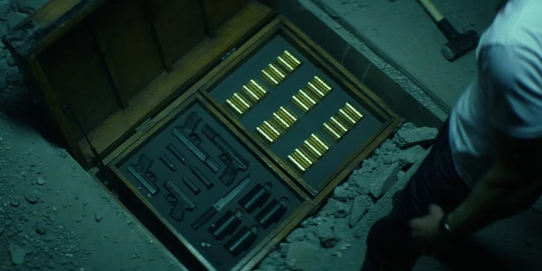 The open emergency trunk with weapons and gold coins in John Wick