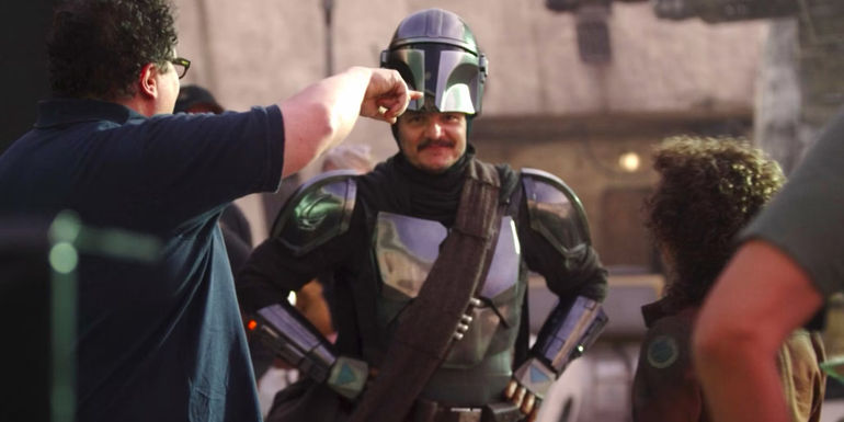 Pedro Pascal poses as Din Djarin behind the scenes of The Mandalorian season 2 episode 1 in Disney Gallery: The Mandalorian