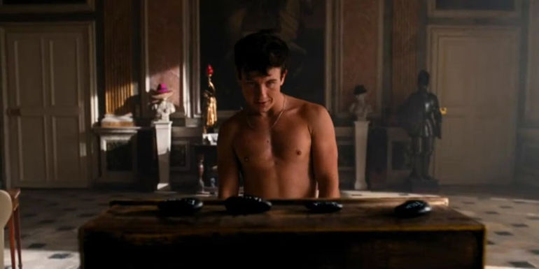 Oliver shirtless looking at the family's death stones at the end of Saltburn