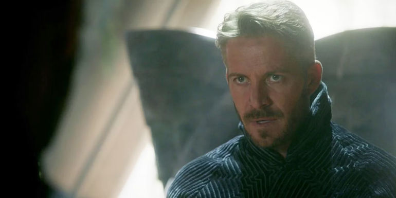 The Dark King looks sternly at another character.