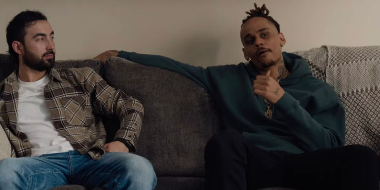 Goody and Dolo sitting next to one another on the couch