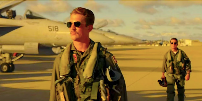 Rooster (Miles Teller) walking away angrily from Maverick (Tom Cruise) in Top Gun 2