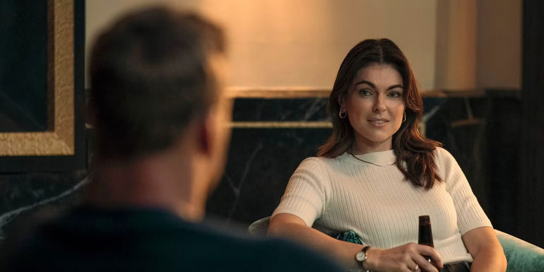 Serinda Swan as Karla Dixon looking at Alan Ritchson as Reacher in Reacher season 2