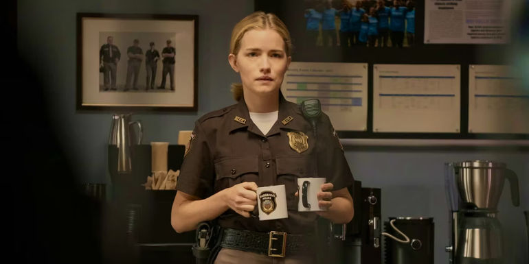 Willa Fitzgerald as Roscoe holding coffee cups in Reacher season 1