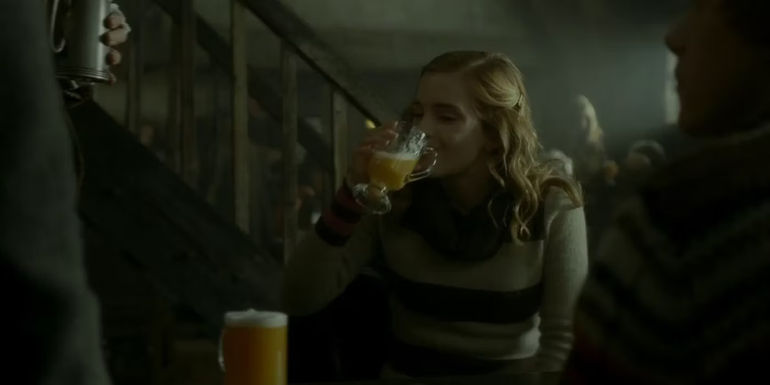Hermione (Emma Watson) drinking butterbeer in Harry Potter