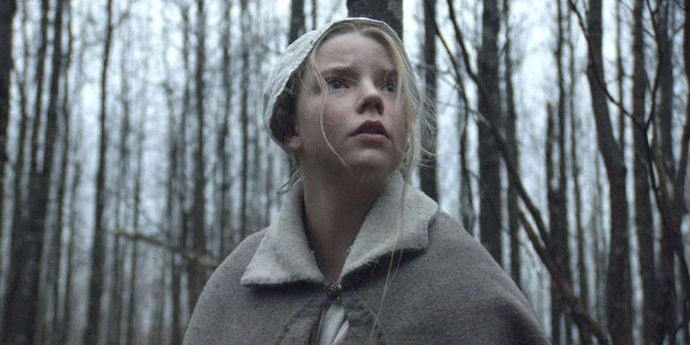 Anya Taylor-Joy as Thomasin standing in the woods in The Witch