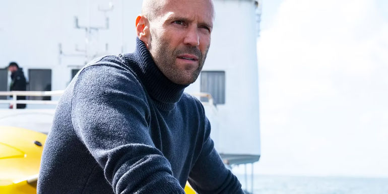 Jason Statham on a boat looking in the distance in The Meg